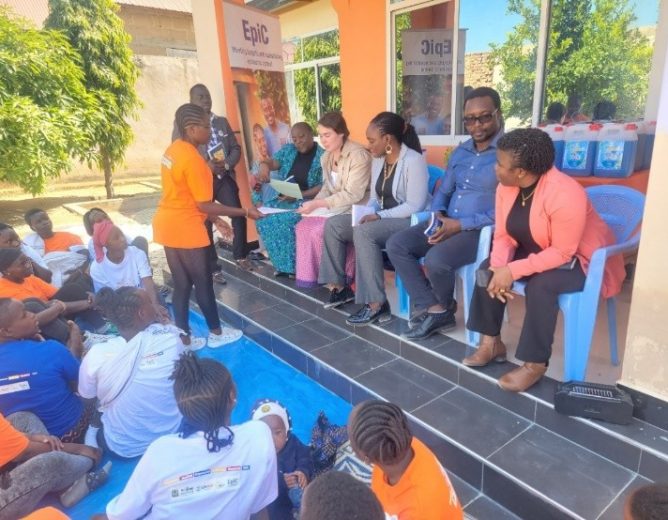 UNICEF and USAID delegates discussing with AGYW (Unique Group) at Kitwiru and (L) the delegates observing the duck project